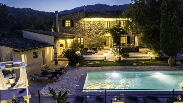 A stone building with a pool, outdoor seating, and a covered area. - JAUME RAMONA. Stunning newly renovated villa in a formidable setting (Pollensa)