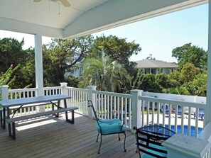 Relax on the deck overlooking the pool and lush gardens.