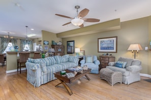 A spacious living room with a sectional sofa, a chaise lounge, a coffee table, and a ceiling fan. - 5 BR BEAUTY-WALK/BIKE TO REHOBOTH BEACH & BOARDS-Pool Cmmty- 19853 Church St. (Rehoboth Beach)