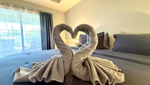 A bed with a heart-shaped towel arrangement. - * Where beach days, pool nights, and unforgettable memories begin! * (Englewood)