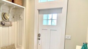 A white door with a small window, a bench with a cushion, and a wicker basket on a shelf. - * Where beach days, pool nights, and unforgettable memories begin! * (Englewood)