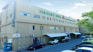 A hotel with a sign reading "SEMRAMIS HOTEL" and a sign for "Gulf Tours" below it. - OYO 112 Semiramis Hotel (Manama)