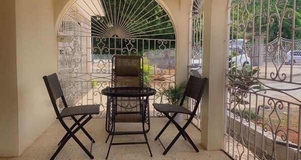 Enjoy a balcony with a table and chairs, offering a view of the surrounding area.