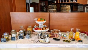 A breakfast buffet with various food items and condiments.