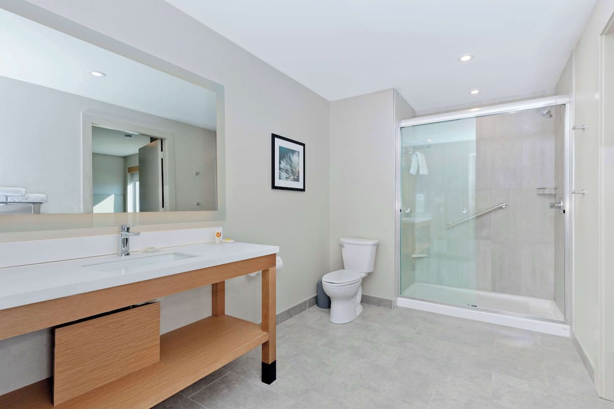 rainfall showerhead, designer toiletries, hair dryer, towels