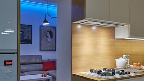 A modern kitchen with a built-in stove, a white countertop, and wooden cabinetry.
