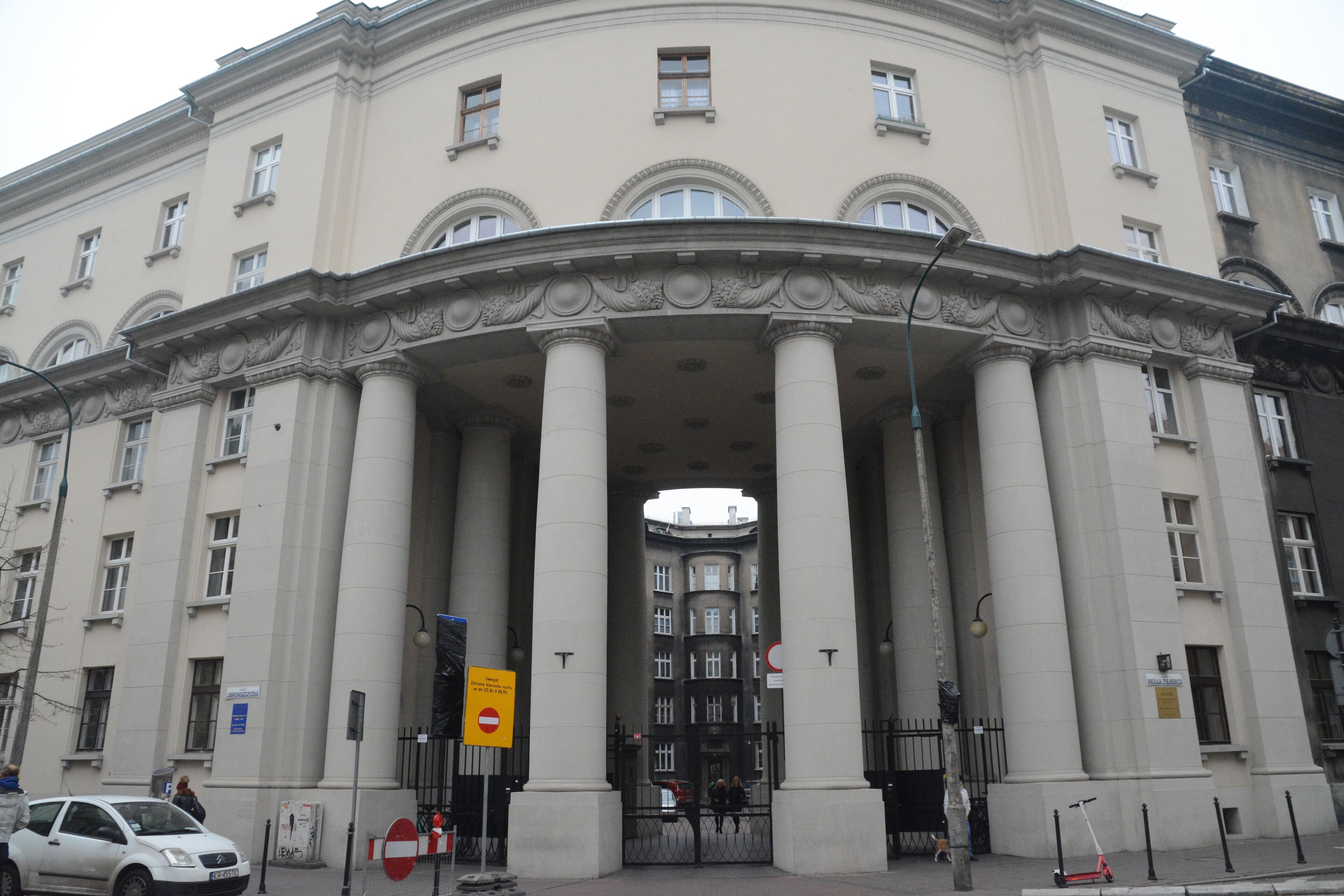 A large, classical building with a grand entrance featuring tall columns and a detailed facade.