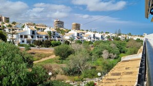 A residential area with white houses, some with balconies, and a hilly backdrop. - modern, newly renovated apartment in Cabo Roig, beach within walking distance (Orihuela)