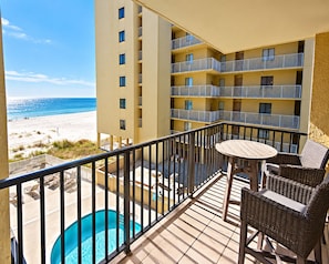 A balcony with a pool, beach view, and multiple floors of a building. - Time to get… 🎶 Knee deep in the water somewhere! 🎶 on island time! (Gulf Shores)