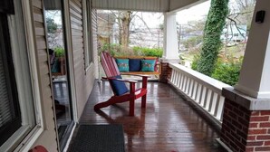 A covered porch with wooden flooring, a red bench, and a cushioned bench with colorful cushions. - 2 blocks to North Chattanooga revitalized riverfront restaurants and bars. (Chattanooga)