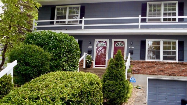 A two-story house with a red door, white railings, and a garage. - SWEET! near Downtown PWR & LIGHT Westport KUMC (Kansas City)