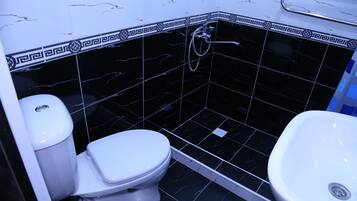 Shower, rainfall showerhead, slippers, towels