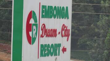 A sign for Embonga Dream City Resort with a directional arrow.