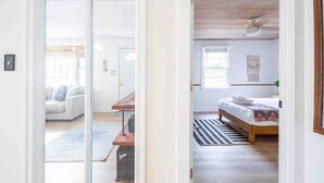 A room with a bed, a desk, and a sofa.