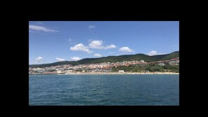A coastal town with buildings along the shore and a view of the sea.