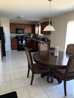 Enjoy meals in the kitchen with a round dining table and comfortable seating.