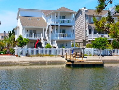 4bd Canal Front home with an Elevator, dock, fenced back yard, 2 master suites