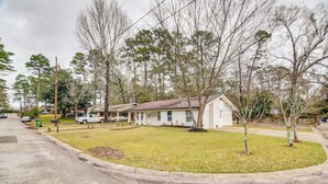 A single-story house with a front porch, a small front yard, and a driveway.