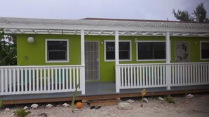 A two-story house with a green exterior and white railings. - Sagusta Gardens NCA 1 (Whitby)