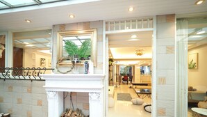 A modern interior with a fireplace, a dining area, and a living room. - Near StayReal Location (Taipei)