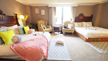 A hotel room with two beds, a sitting area with chairs, a large window, and a decorative lamp.