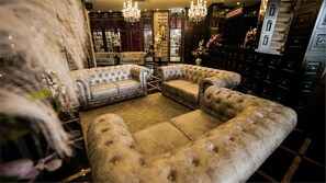 A luxurious room with a large, tufted sofa set and a chandelier. - 1969 Ipoh Garden (Ipoh)