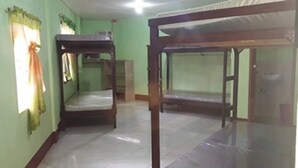 A room with bunk beds and a window with curtains. - EG Rusiana Boarding House (Claver)