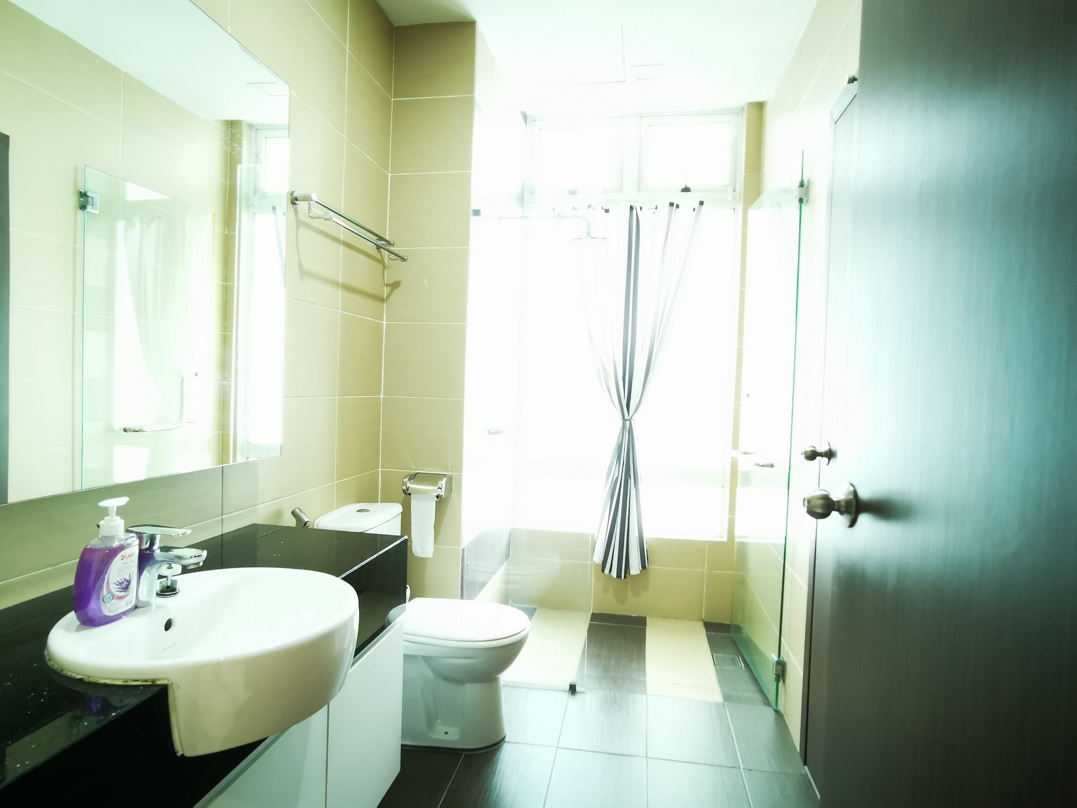 A modern bathroom with a sink, toilet, and shower area.