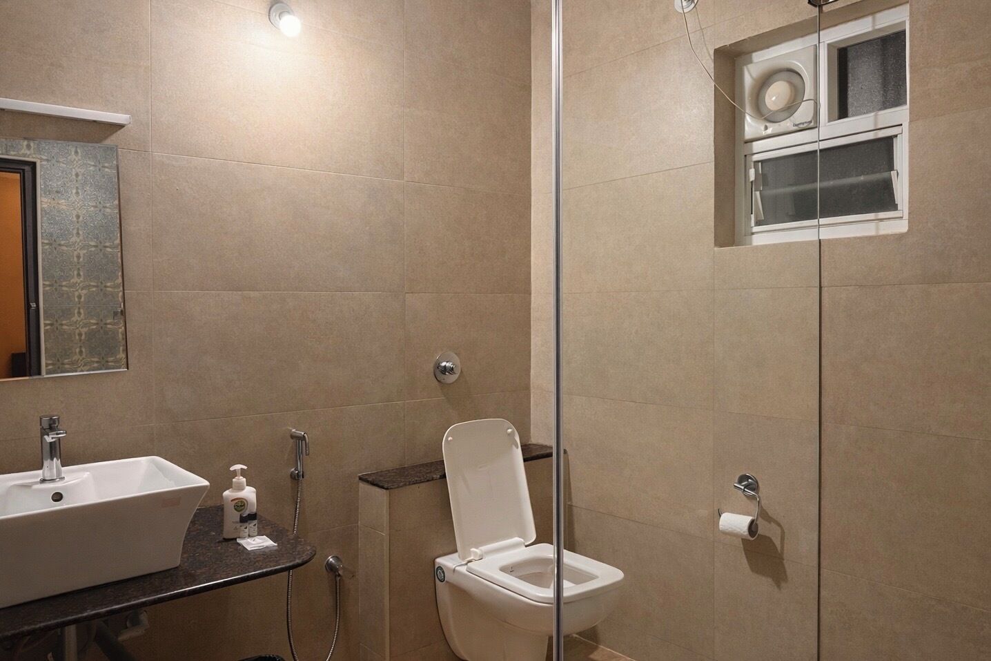 A bathroom with a sink, toilet, and shower.