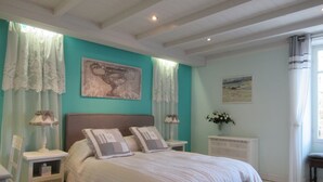 A bedroom with a bed, nightstands, a dresser, and artwork on the walls. - 4 - Star Holiday Home on the Charente River. (Bourg-Charente)