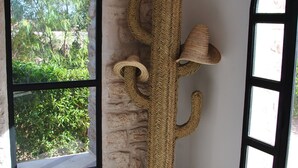 A room with a large window, a woven cacti sculpture, and a door with glass panels. - Villa l "Ambre d'Essaouira (Essaouira)