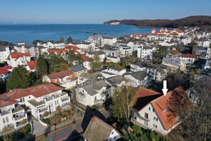 A coastal town with white buildings and red roofs, a pier extending into the sea, and a clear view of the ocean. - Quiet and yet centrally located in Binz (Binz)