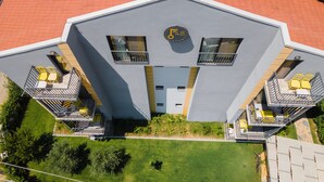 A modern building with balconies, a central entrance, and a sign indicating 48 apartments. - F48 Homes (Fethiye)