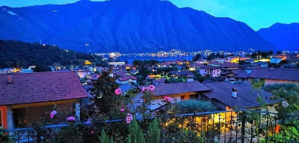 A coastal town with houses and a mountain in the background.