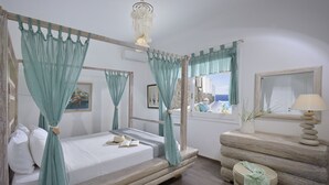 A bedroom with a four-poster bed, a wooden dresser, and a view of the sea through a window. - MYKONOS CALYPSO SUNSET LUXURY VILLA POOL-HOT TUB (MYKONOS)