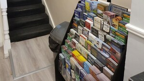 A staircase with a book display at the bottom.