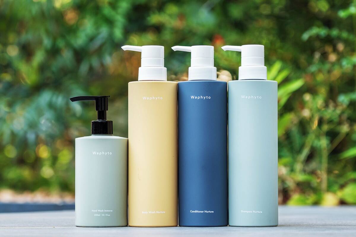 Four bottles of Waphyto personal care products with pump dispensers, each labeled with a different product name.