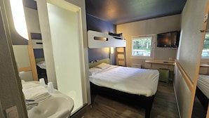 A compact bedroom with a bunk bed, a bedside table, a TV, and a window. - B&B Hotel Thionville Yutz A31 (Yutz)