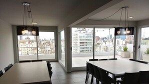 A modern dining area with large windows and a city view. - Independencia 1302 10A by HB (Buenos Aires)