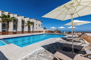 Seasonal outdoor pool, pool umbrellas, pool loungers