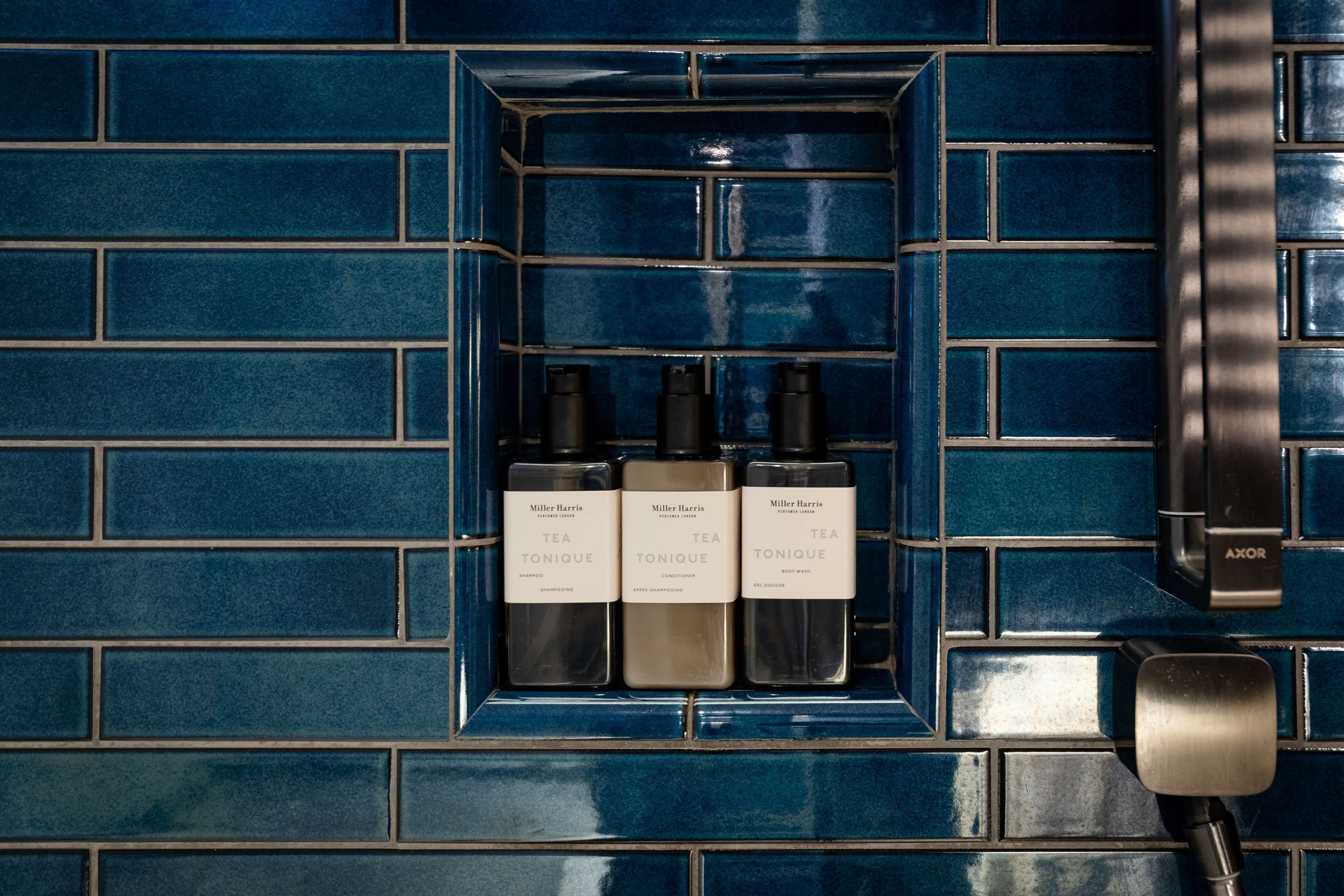 designer toiletries, hair dryer, bathrobes, slippers