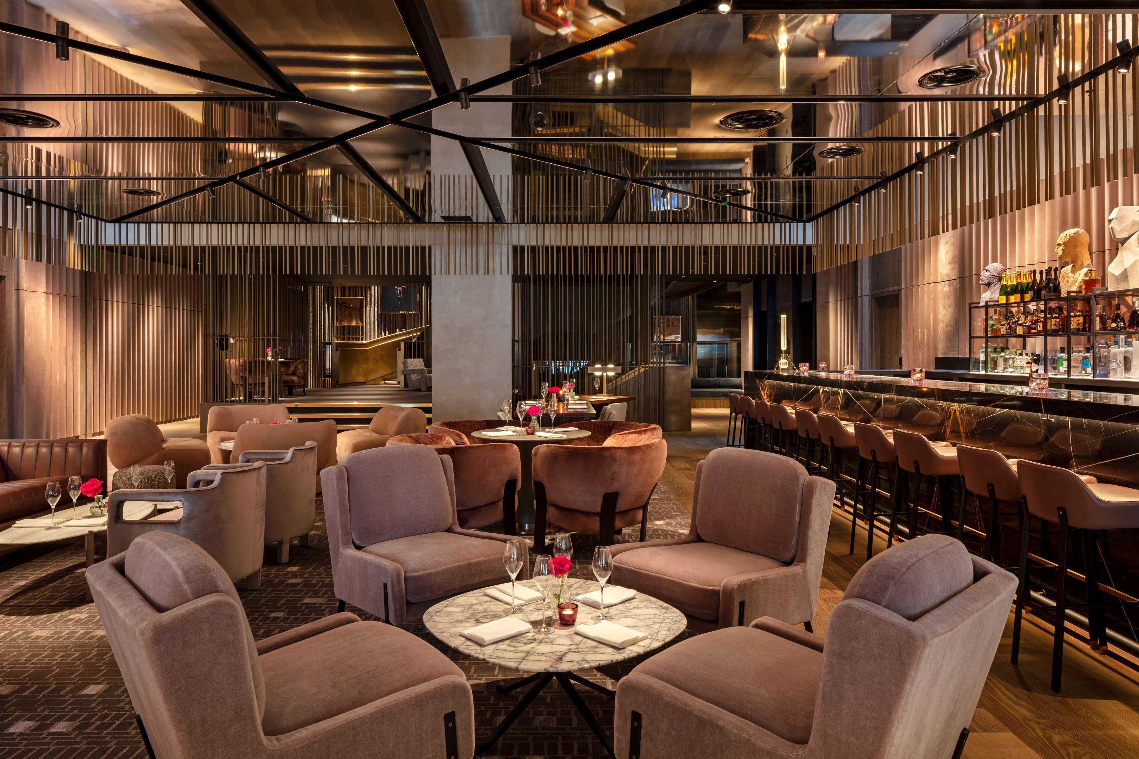 A modern bar area with seating and a bar counter.