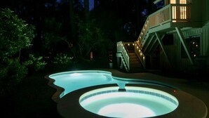 A hot tub and a staircase leading to a deck.