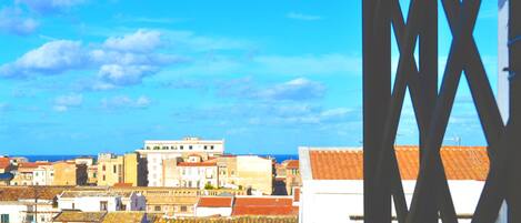 A view of a coastal town with buildings and a clear sky.