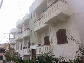 A row of white buildings with balconies and arched windows. - Irene Apartments (Hersonissos)