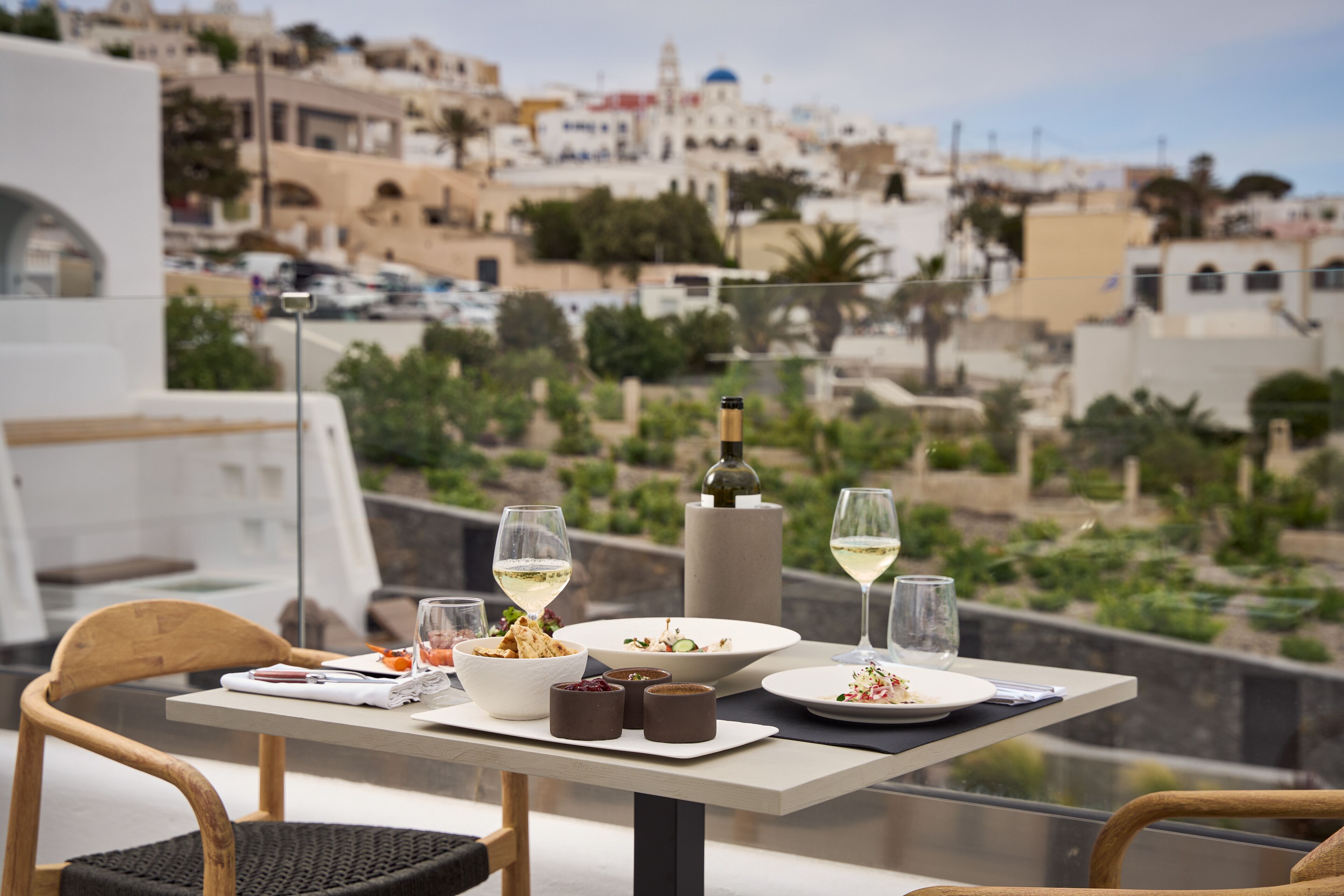 A table set for a meal with a view of a cityscape.