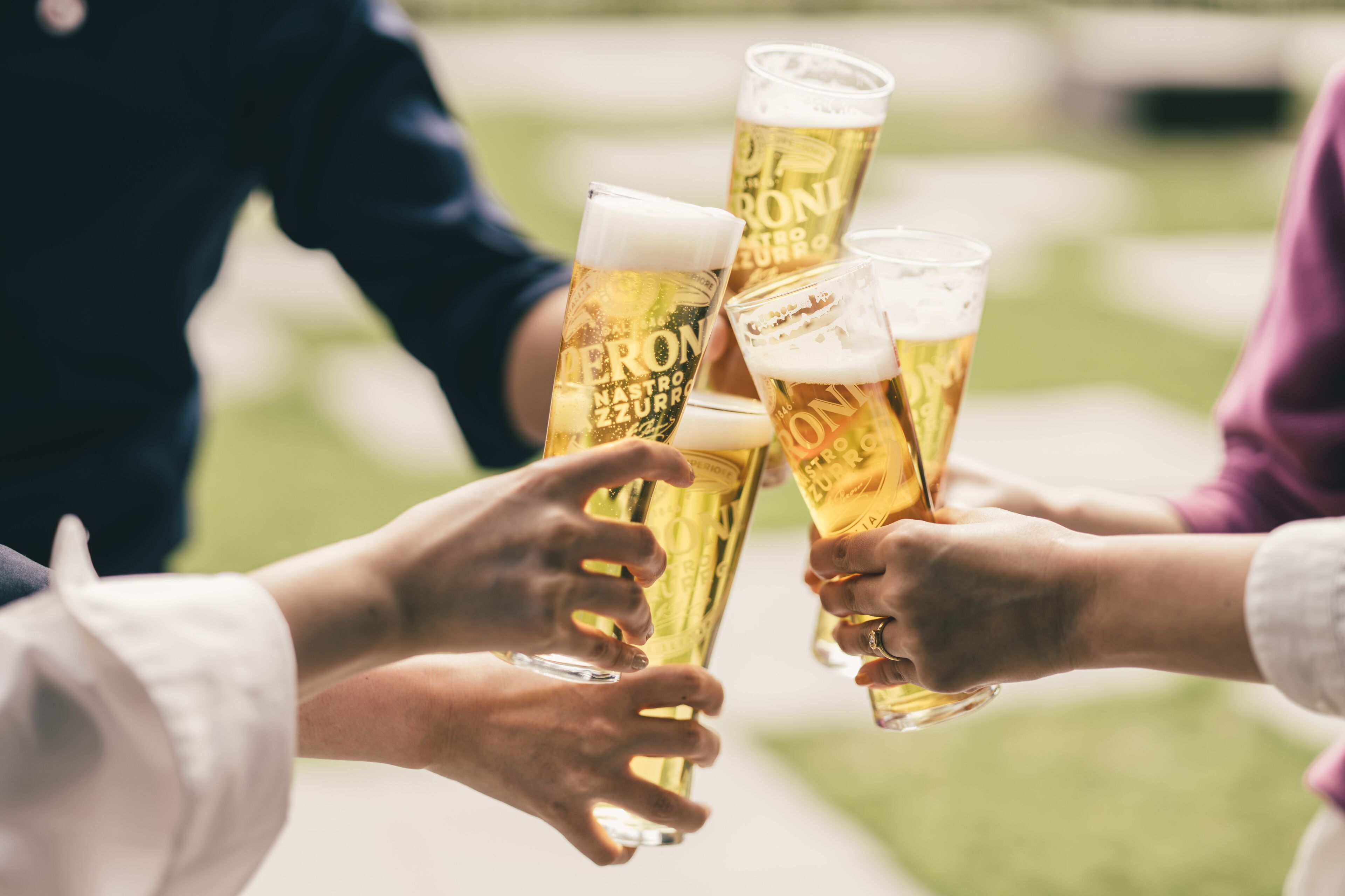 A group of people toasting with beer glasses.