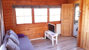Relax in this inviting room with a sofa, table, and large window.