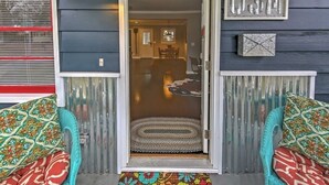 A doorway leading to a dining area with a rug and a bench.