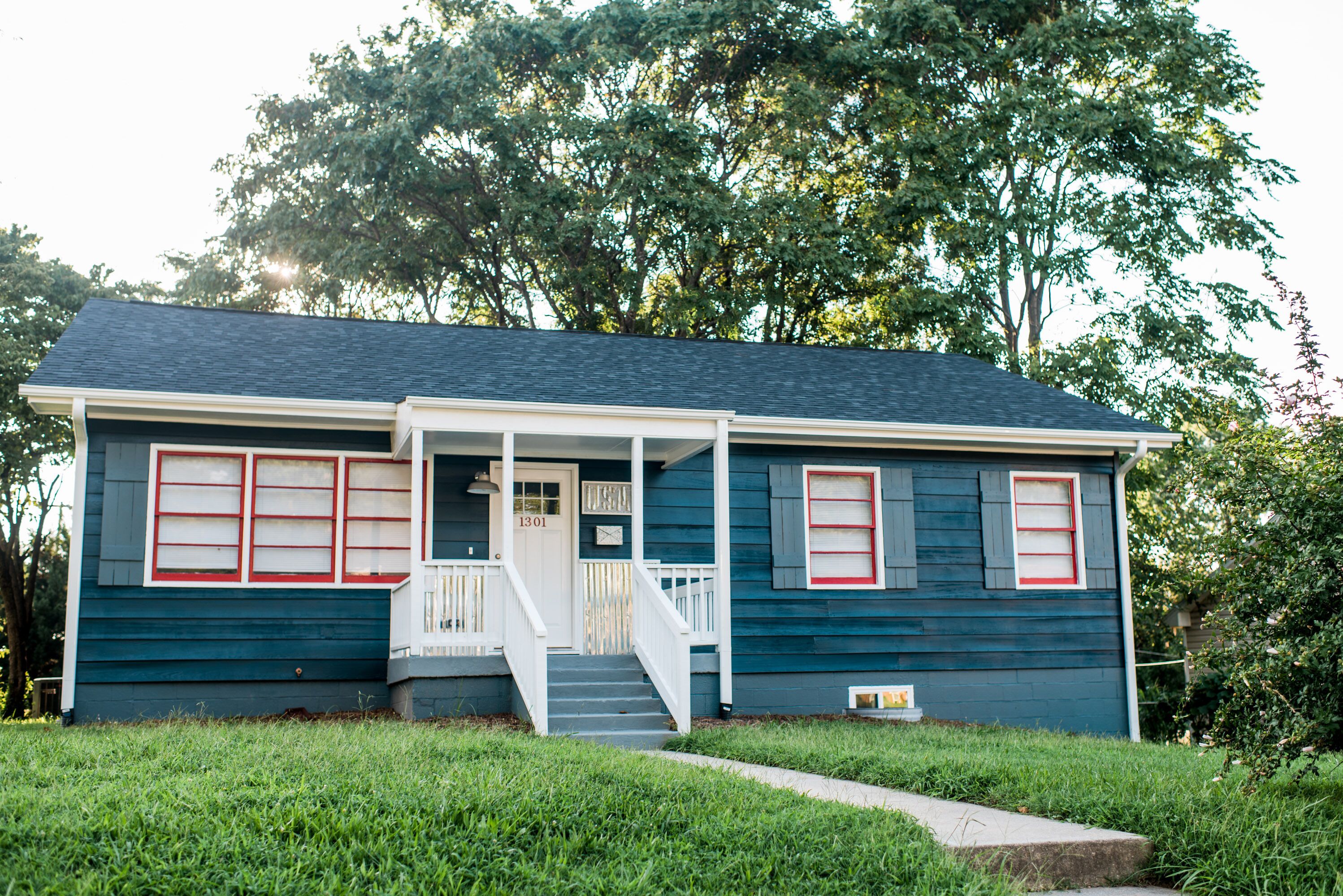 A two-story house with a front porch, a staircase, and a mailbox.